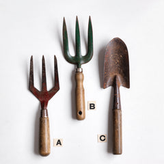 Three good quality vintage garden tools: two hand forks and a trowel, all with polished wooden handles and original paint.